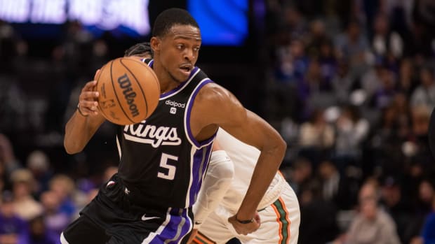 Feb 22, 2024; Sacramento, California, USA; Sacramento Kings guard De'Aaron Fox (5) dribbles past San Antonio Spurs guard Tre Jones (33) during the second quarter at Golden 1 Center. Mandatory Credit: Ed Szczepanski-USA TODAY Sports